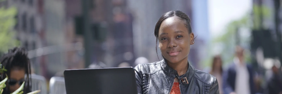 Hero Image of student looking at camera with laptop